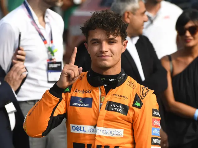 McLaren's Lando Norris holds up his right index finger in celebration