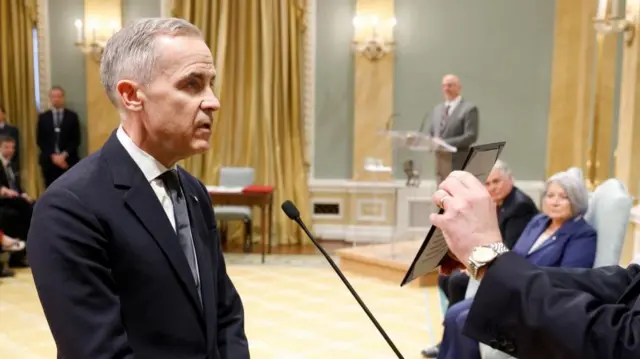 Carney taking his oath inside the ballroom of Rideau Hall