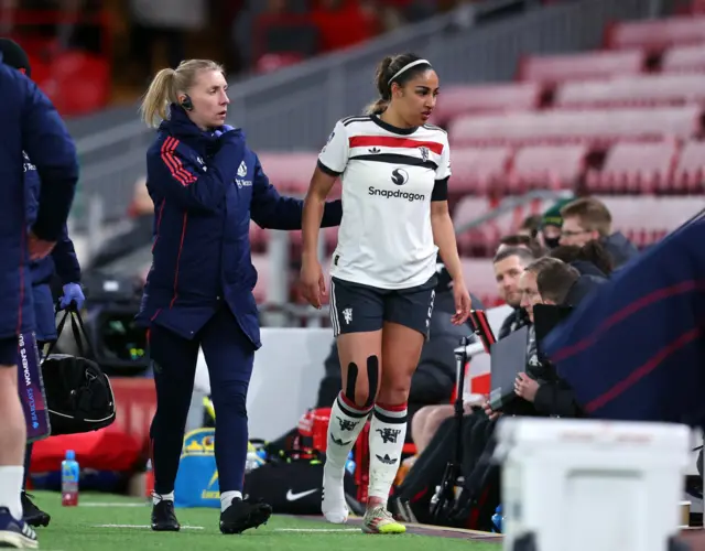 Manchester United's Gabby George is substituted after sustaining an injury.