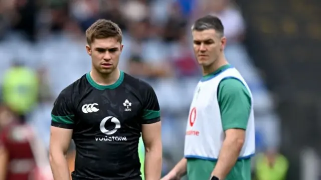 Johnny Sexton watches on as Jack Crowley lines up a kick in the warm-up