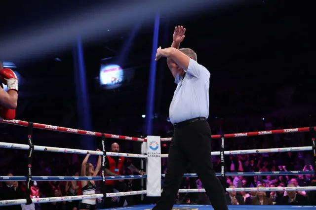 Referee waving his arms in the air in the ring