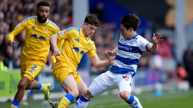 Koki Saito tackles Leeds' Dan James