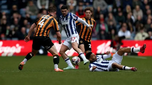 Alex Mowatt of West Bromwich Albion wins the ball from Hull's Charlie Hughes