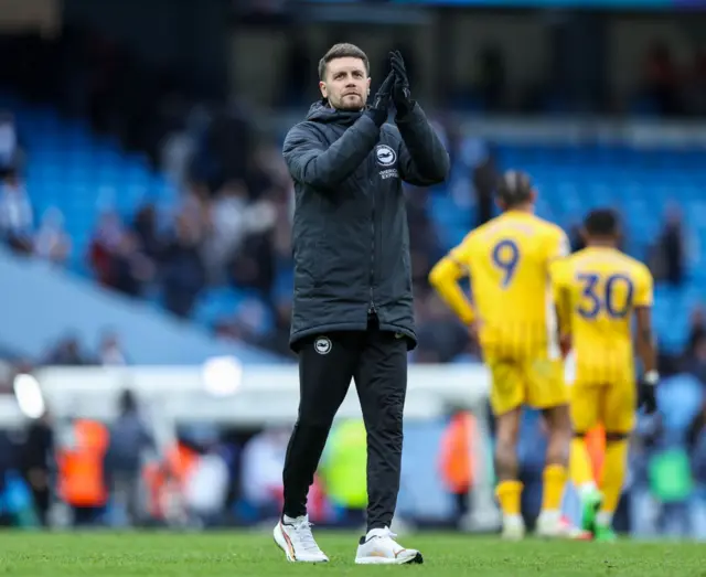 Brighton & Hove Albion manager Fabian Hurzeler applauds the fans