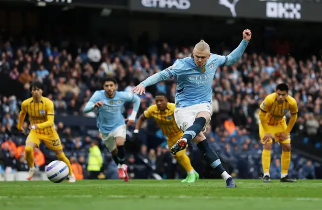 Manchester City's Erling Haaland scores their first goal from the penalty spot.