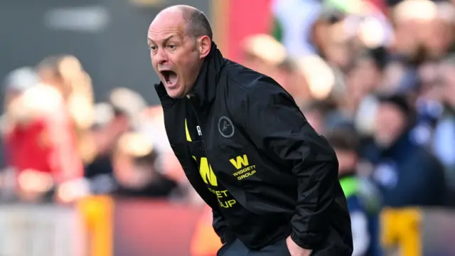 Millwall manager Alex Neil screams instructions on the touchline