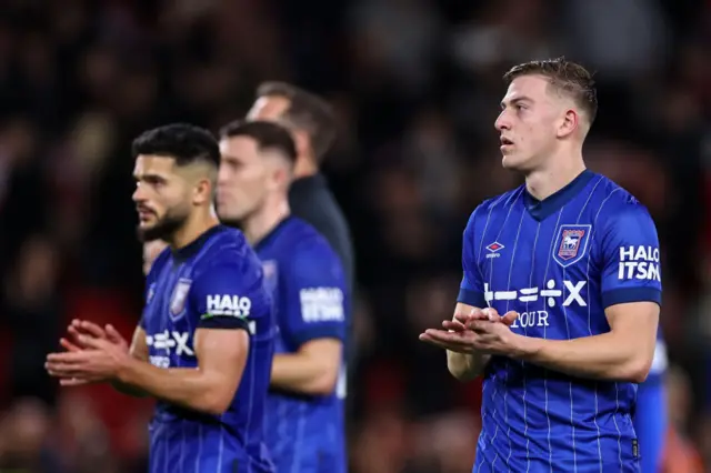 ejected Liam Delap of Ipswich Town applauds the fans at full time.