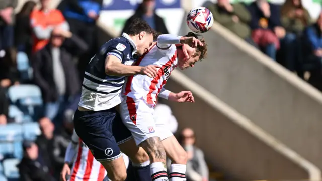 Millwall's Jake Cooper beats Stoke's Wouter Burger in the air