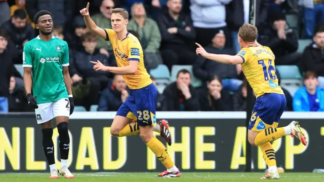 Derby's Harrison Armstrong raises his finger into the air after scoring at Plymouth