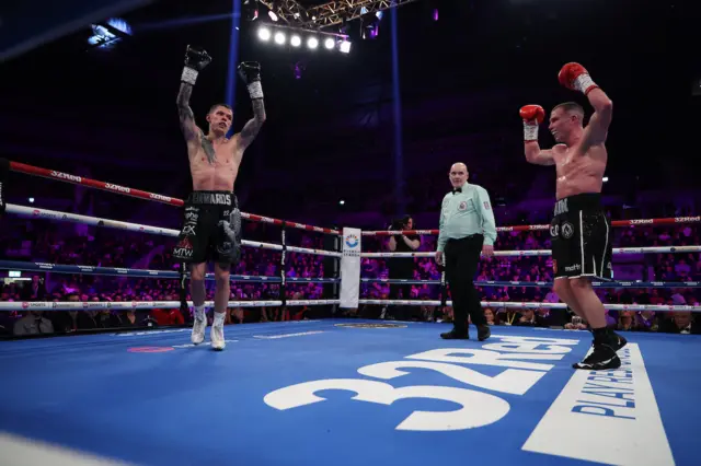 Charlie Edwards and Andrew Cain raise their hands in the air at the end of their fight