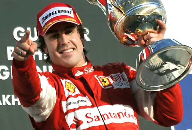 Fernando celebrates with the winner's trophy after the 2010 Bahrain Grand Prix