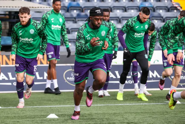 Hibs players warming up at Rugby Park