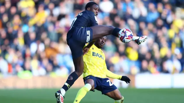 Jeremy Ngakia of Watford battles for possession with Oxford's Siriki Dembele