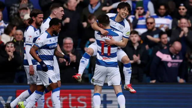 QPR's Koki Saito is held aloft by team-mate Paul Smyth after scoring against Leeds