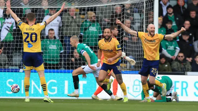 Derby players celebrate with their arms outstretched after Marcus Harness' goal at Plymouth