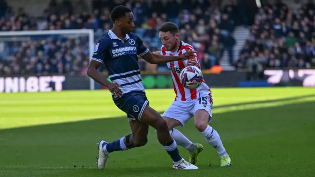 Stoke City midfielder Jordan Thompson on the ball and under pressure from Millwall midfielder Raees Bangura-Williams