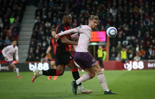 Kristoffer Ajer of Brentford is challenged by Antoine Semenyo