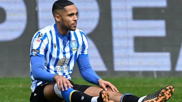 Sheffield Wednesday's Max Lowe sits down after sustaining an injury