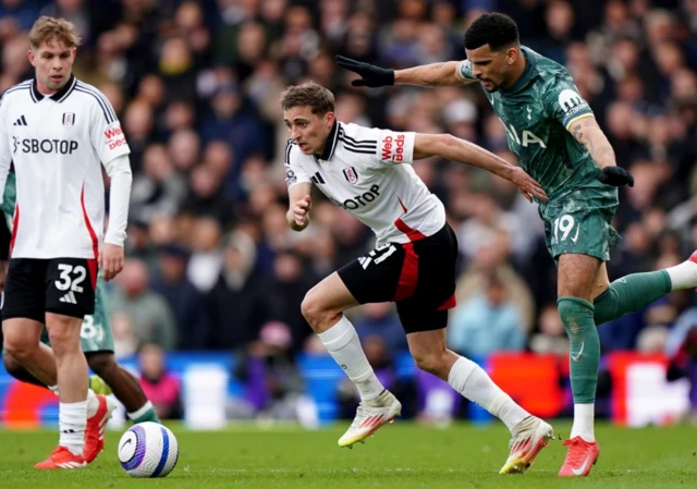 Fulham's Timothy Castagne (left) and Tottenham Hotspur's Dominic Solanke battle for the ball