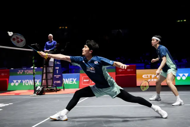 South Korea's Kim Won Ho (C) and South Korea's Seo Seung Jae (R) play a return