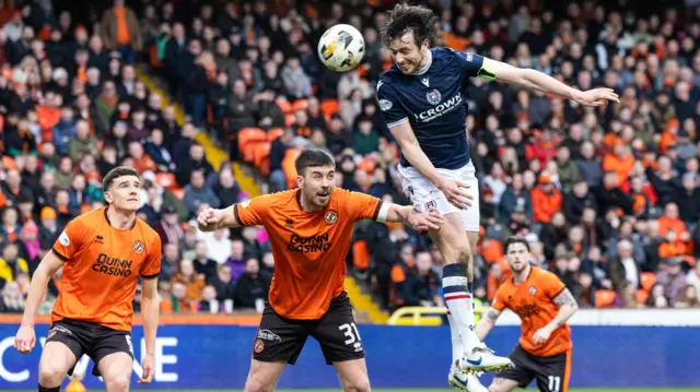 Joe Shaughnessy has a headed chance for Dundee against Dundee United