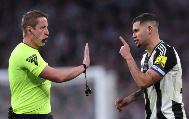 Newcastle United's Bruno Guimaraes remonstrates with referee John Brooks