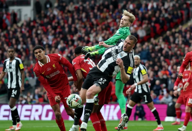 Newcastle United's Dan Burn in action with Liverpool's Caoimhin Kelleher