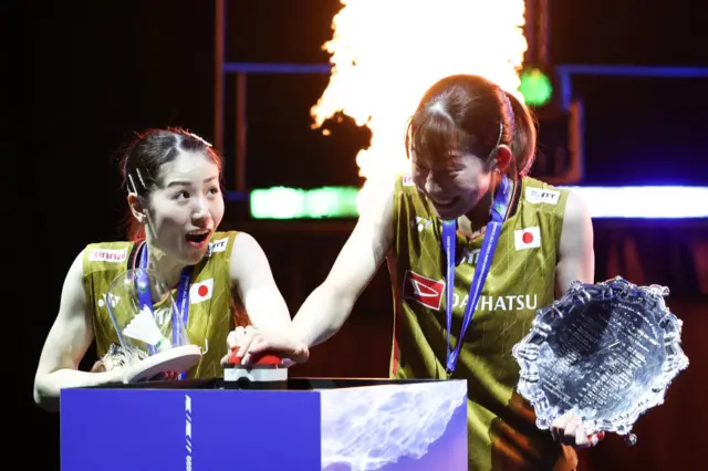 Winners Japan's Chiharu Shida (L) and Japan's Nami Matsuyama (R) celebrate with their trophies during the podium ceremony
