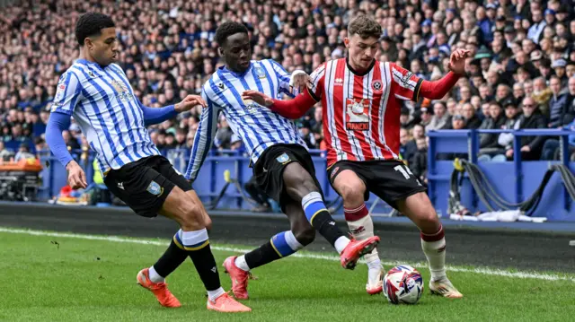 Sheffield Wednesday's Djeidi Gassama tackles Sheffield United's Harrison Burrows