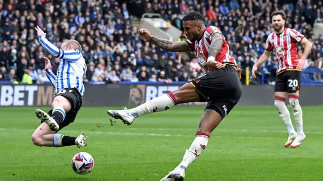 Tyrese Campbell sends in a shot at goal as Barry Bannan stretches to try and block