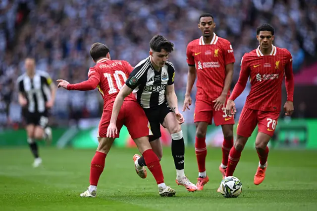 Tino Livramento of Newcastle United is challenged by Alexis Mac Allister