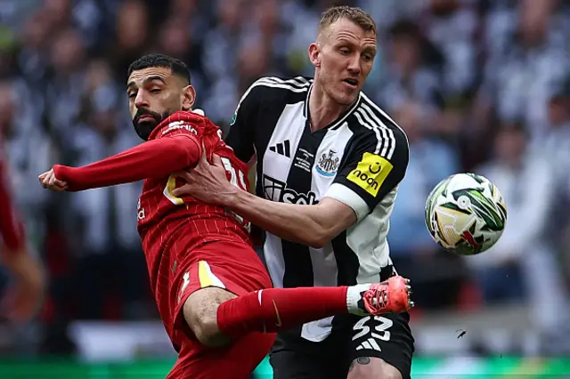 Mohamed Salah (L) vies with Newcastle United's English defender Dan Burn