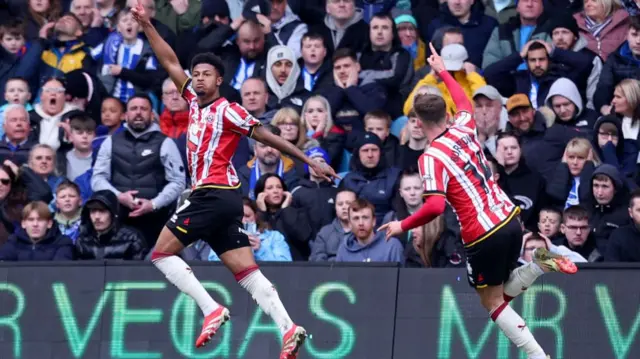 Rhian Brewster has his arm in the air in celebration