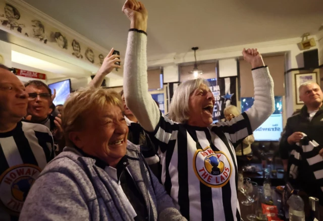 Newcastle United fans celebrate in the Strawberry pub