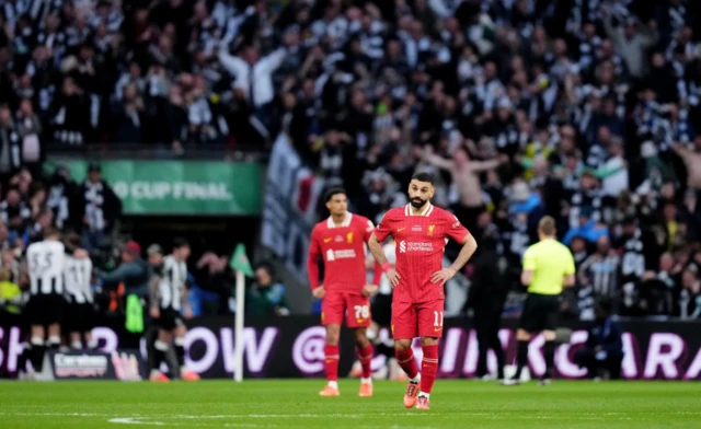 Liverpool's Mohamed Salah (right) stands dejected