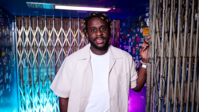 Myles Smith posing for a photo in a lift