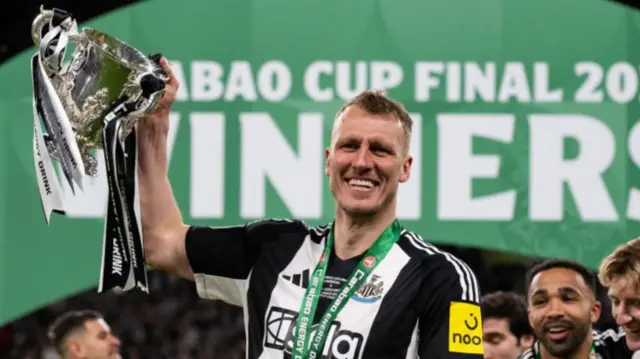 Dan Burn with the Carabao Cup.