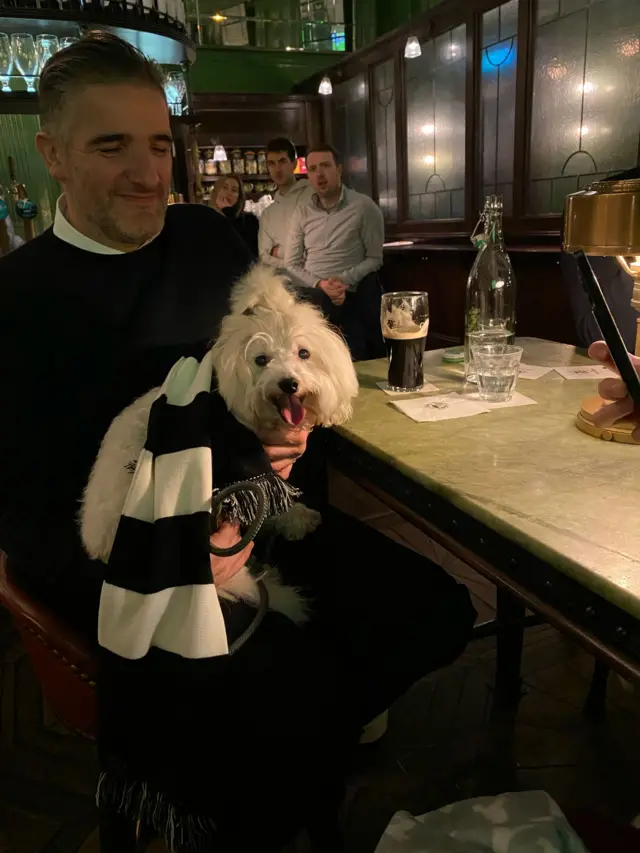 Newcastle fan with dog in pub