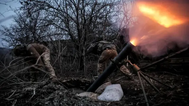 Servicemen of 24th Mechanized brigade named after King Danylo of the Ukrainian Armed Forces fire a 120-mm mortar towards Russian troops at a frontline, amid Russia's attack on Ukraine