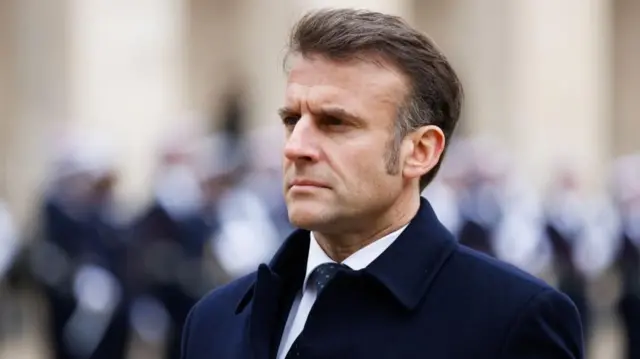 France's President Emmanuel Macron in a blue coat