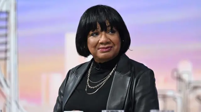 Diane Abbott in a black jumper and leather jacket.