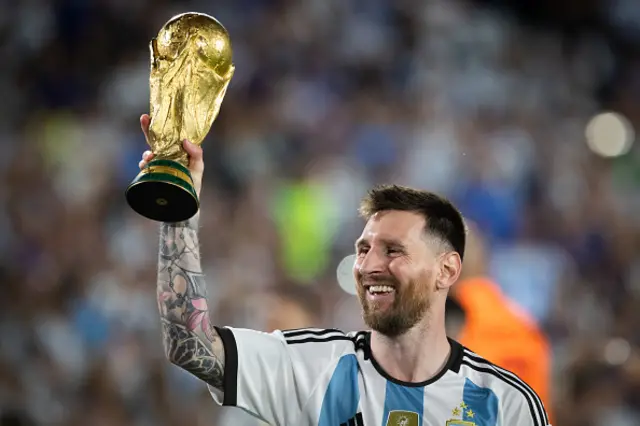 Argentina's Lionel Messi celebrates with the World Cup trophy