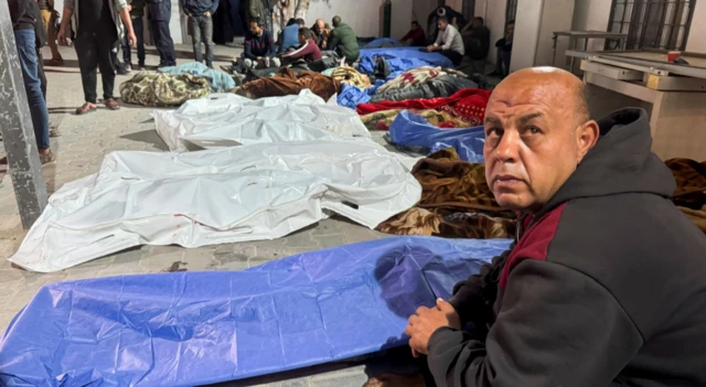 Mourners gather near the bodies of Palestinians killed in Israeli strikes, at a hospital in Gaza City.