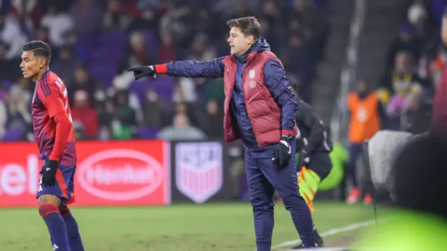 Pochettino passing on instructions to his players.