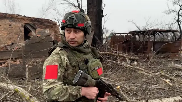 A Russian army soldier walks along a ruined street of Malaya Loknya settlement, which was recently retaken by Russia's armed forces in Kursk