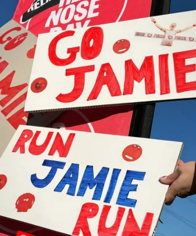 Signs saying 'Go Jamie' and 'Run Jamie Run'