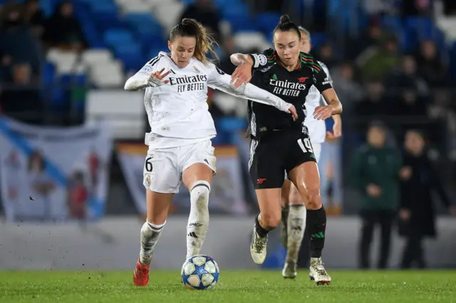 Sandie Toletti of Real Madrid is put under pressure by Caitlin Foord of Arsenal.