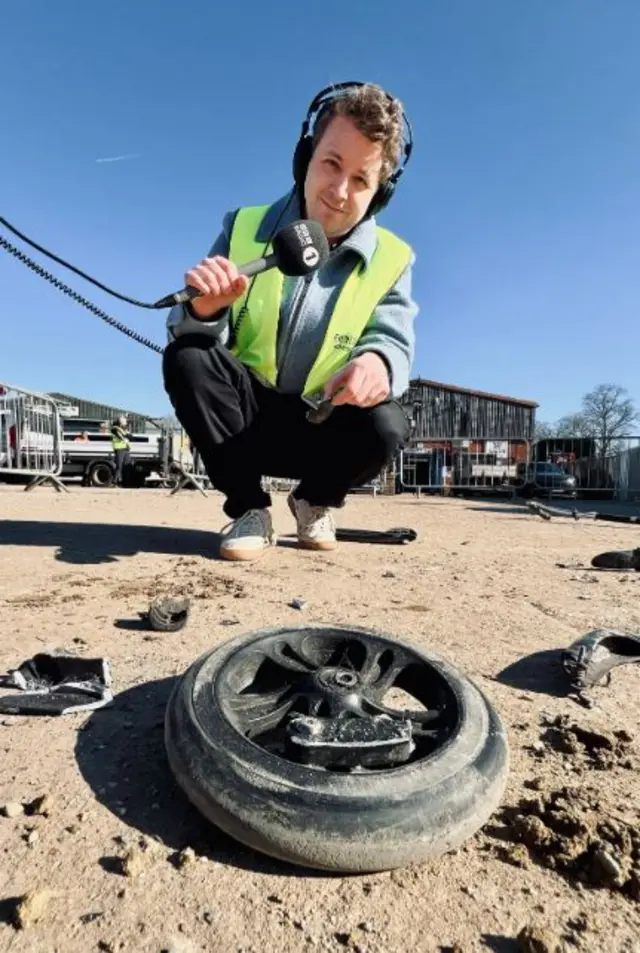 Matt Edmondson poses infront of his crushed scooter