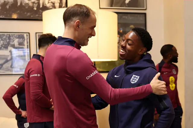 Thomas Tuchel, Head Coach of England, greets Myles Lewis-Skelly