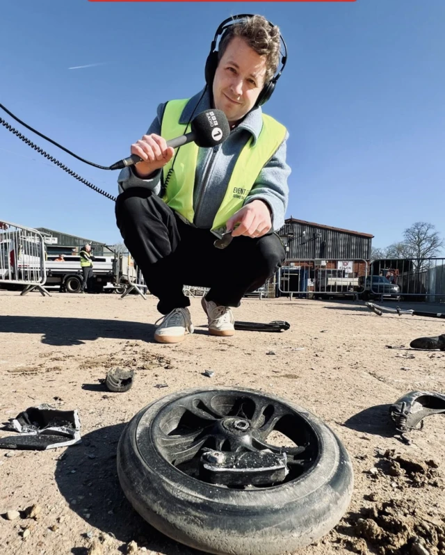 Matt Edmondson stands near his crushed scooter